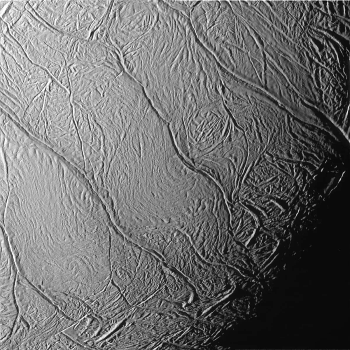 Extreme close-up of Enceladus's icy south polar terrain, showing the long, roughly parallel ridged fractures known as tiger stripes, the warm cracks the geysers vent through.